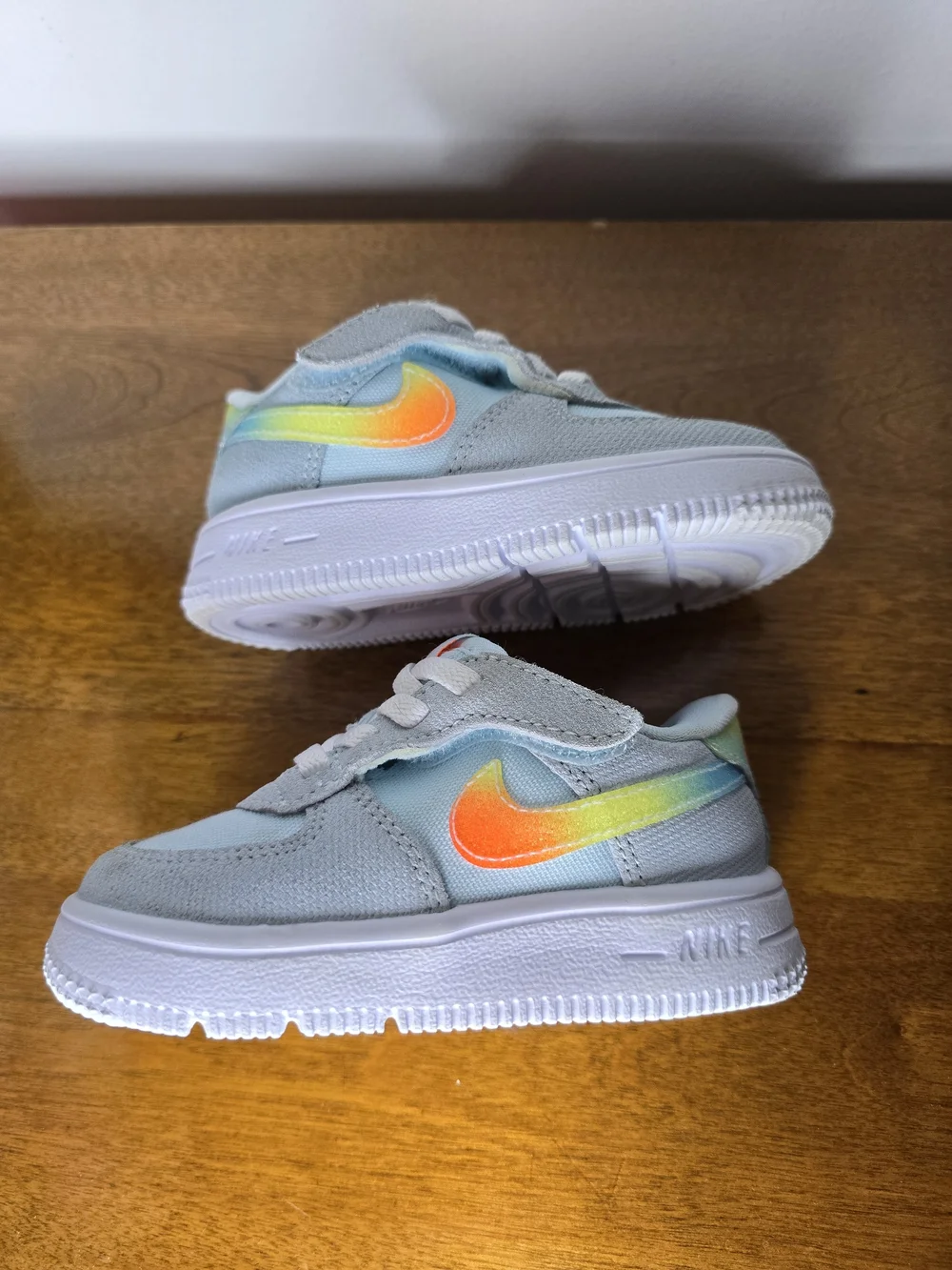 Nike Kids' Light Blue Sneaker with Orange Accents